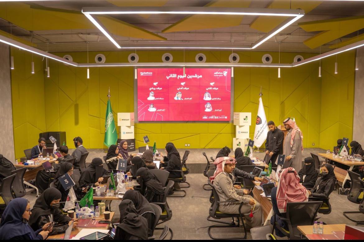 Teams working on innovation challenges at a Saudi hackathon event